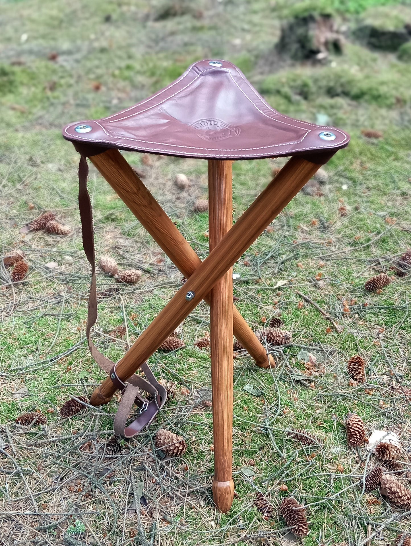 Three-legged stool made of solid ash wood and cowhide